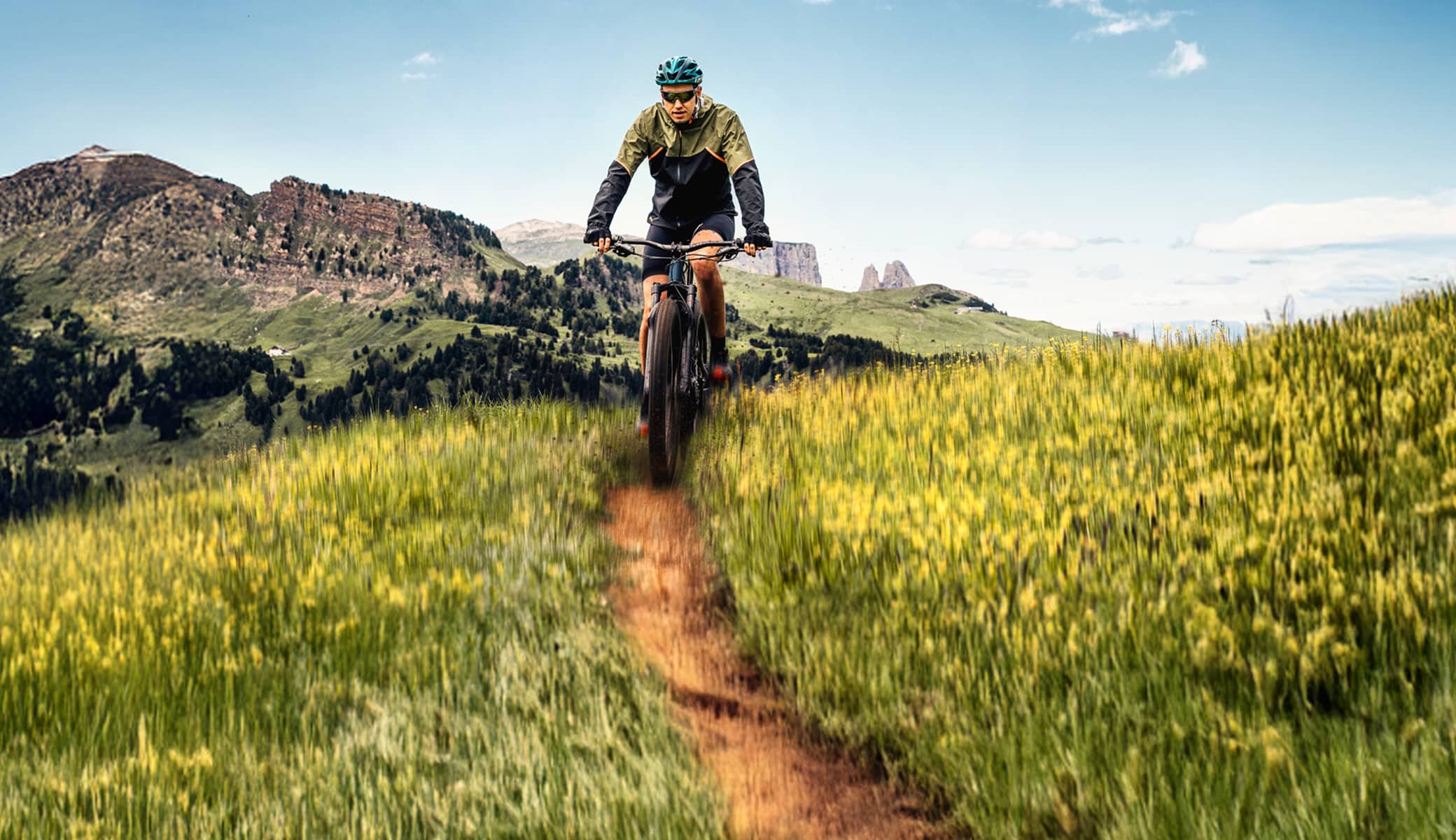 Explore routes for every bike and every ride. Cyclist on a trail in the mountains.