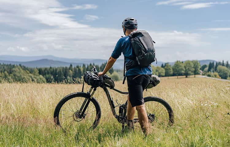 Trekking biker in the fields